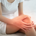 Woman holding a sore and inflammed knee